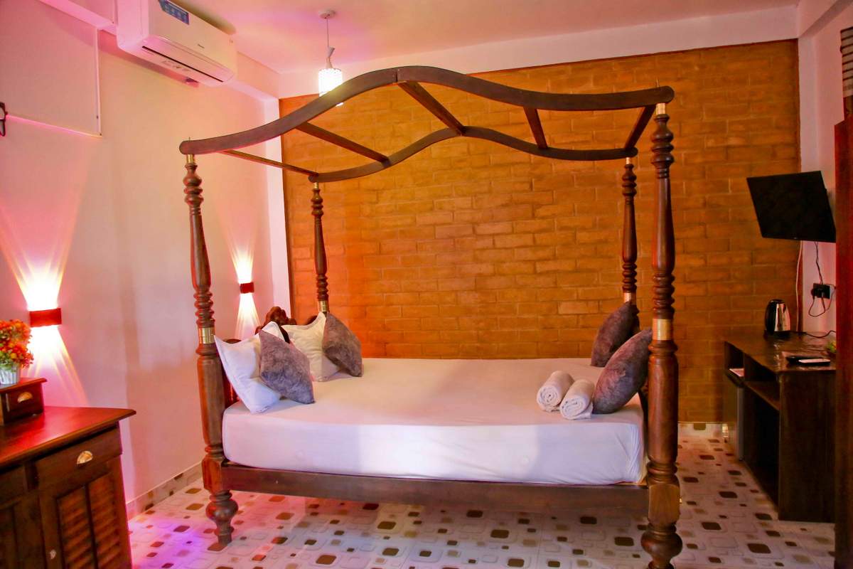 Indoor pool room with canopy bed